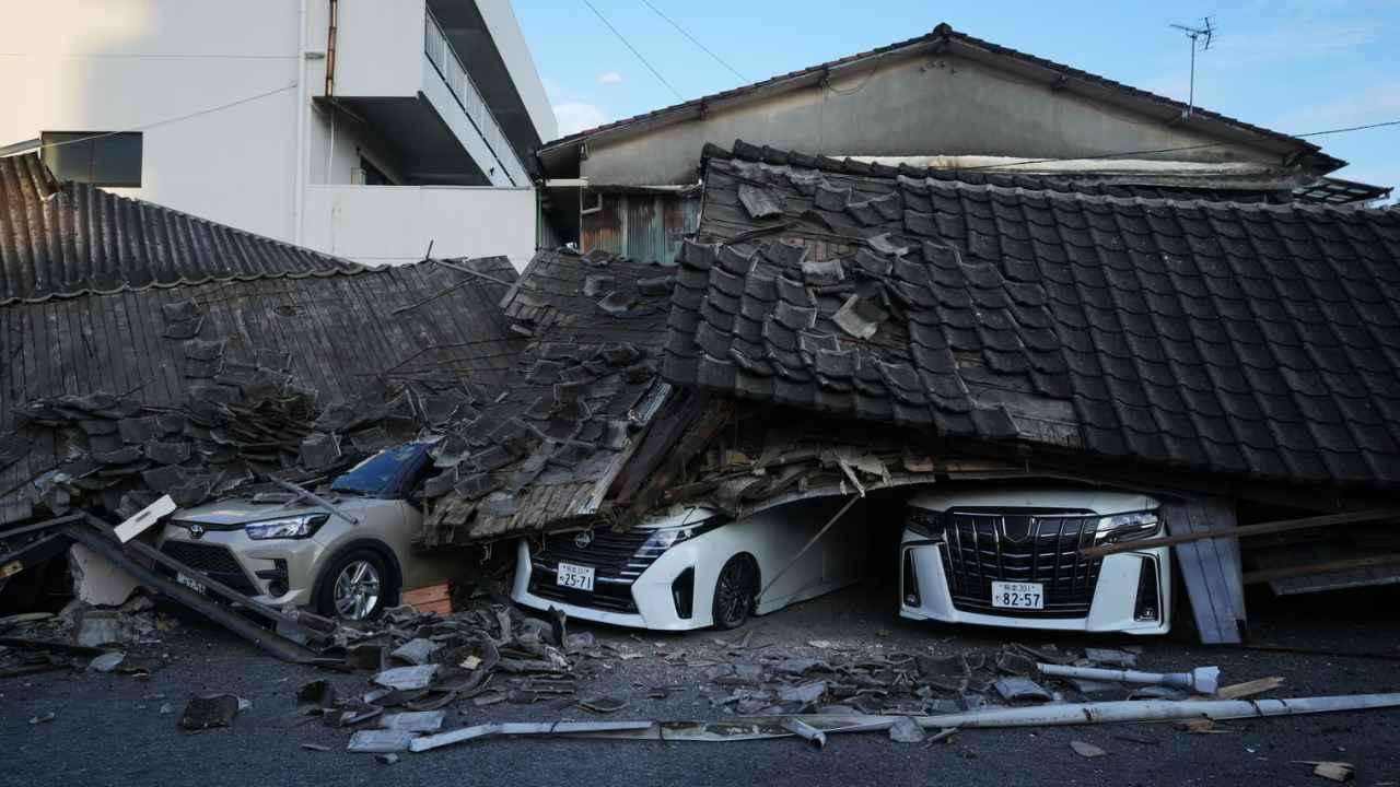 Vehicles lie buried beneath collapsed buildings in Yatsushiro, south-western Japan.jpg